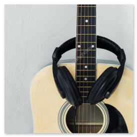 Over-ear headset next to a laptop computer