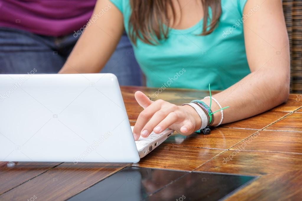 Student using a laptop to take notes in class