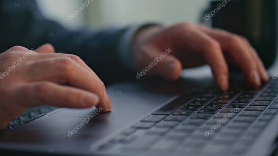 Hands using a Windows desktop computer with performance graphs on screen