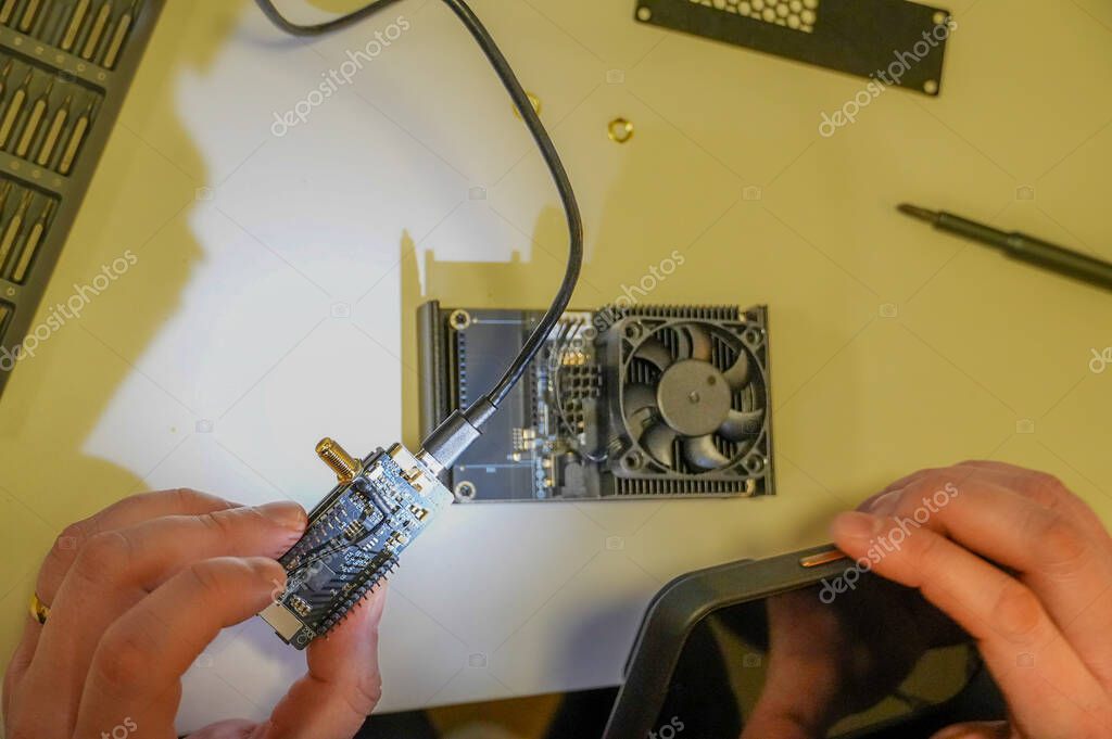 Technician working on an open desktop computer on a workbench